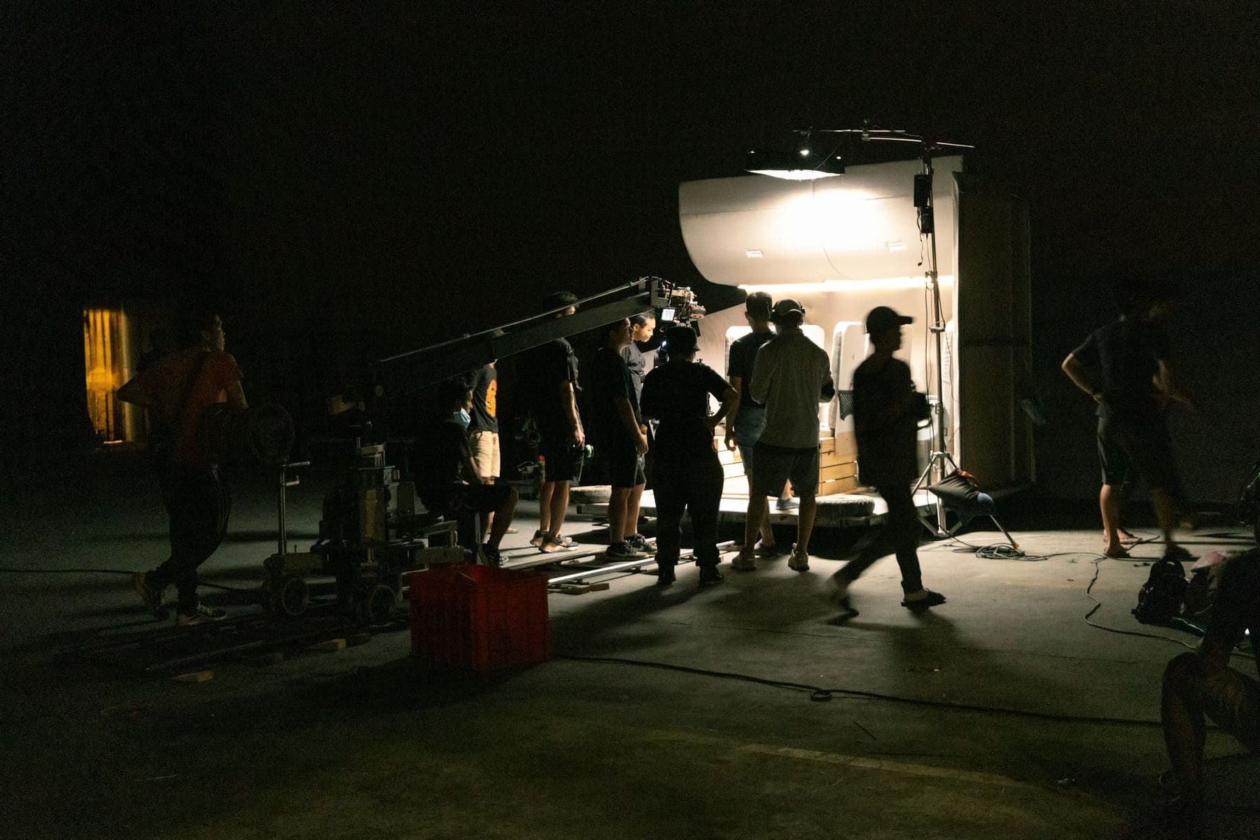 A Story Bakers film crew on a night shoot, lit by a single production light